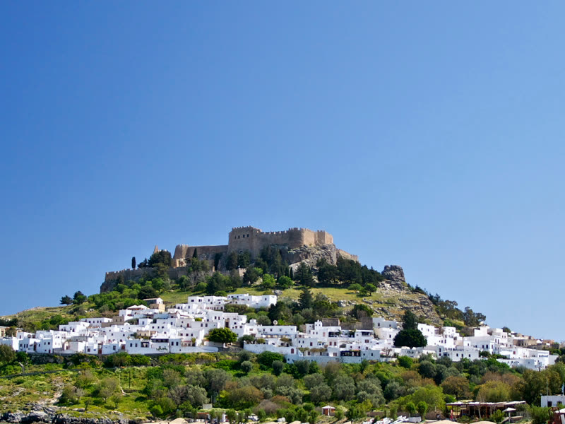 The white village of Lindos below its acropolis on the hill
